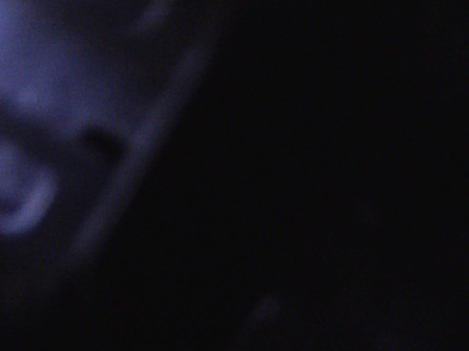 Image is almost entirely black with some faint blueish light on the left
