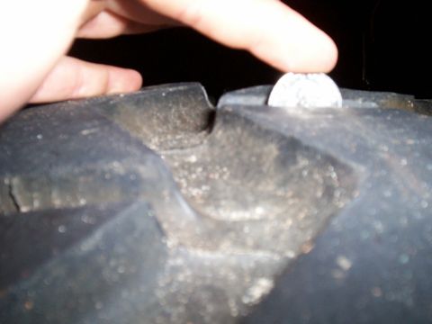 1974 Ford F-100 - Checking tire tread depth with a coin.