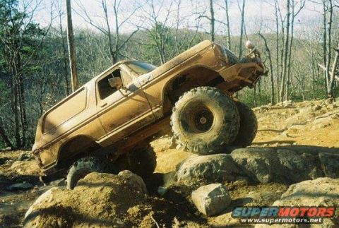 1992 Ford Mustang - Modified SUV tackling a rocky trail with extreme articulation.