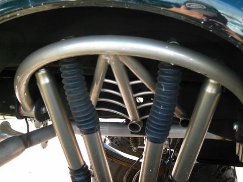 1986 Ford Bronco - Close-up of a modified suspension system with visible shocks and bracing.