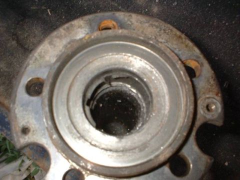 1993 Ford Bronco - A close-up view of a worn and rusty wheel hub assembly, likely needing replacement.