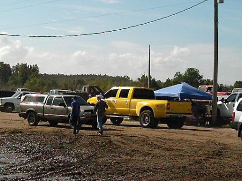 1986 Ford Bronco - A yellow Ford F-350 Super Duty pickup truck is parked at an outdoor event with other vehicles.