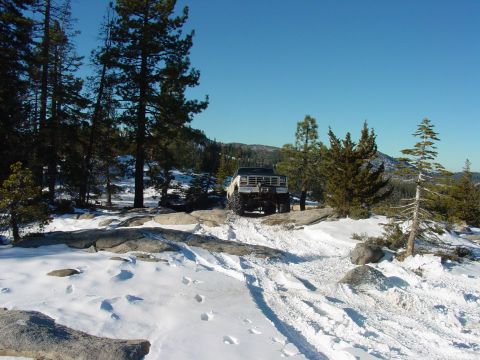 1986 Ford Bronco - 1986 Ford Bronco navigates a snowy mountain path.