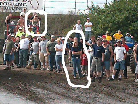 1986 Ford Bronco - A crowd of people are gathered around a tractor at an outdoor event.