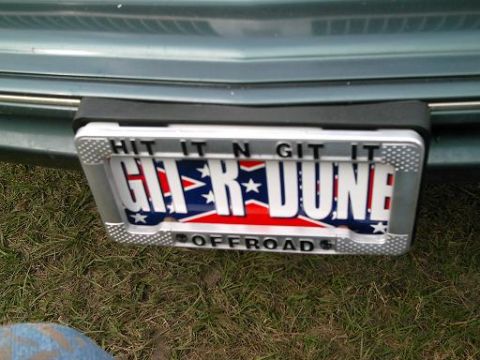 1986 Ford Bronco - A custom license plate frame with "GIT R DONE" and "OFFROAD" text is mounted on the rear of a vehicle.