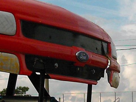 1986 Ford Bronco - The rear of a red Ford Bronco shows damage to the bumper and a missing taillight.