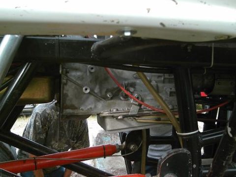 1986 Ford Bronco - A view of the underside of a vehicle, focusing on the transmission and frame components.