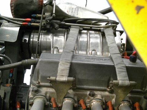 1986 Ford Bronco - Close-up of a modified engine with a supercharger and visible text indicating "MOTORSPORT EVO POWER".