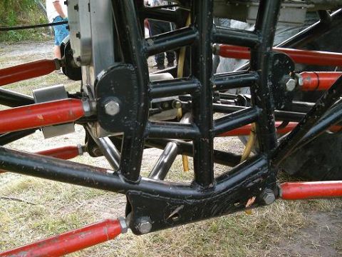 1986 Ford Bronco - The intricate suspension system of a custom vehicle is visible in this close-up shot.