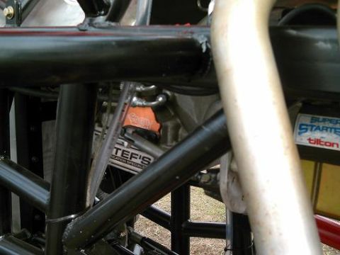 1986 Ford Bronco - Detail of a race car's internal structure and engine components, including a Tilton Super Starter label.