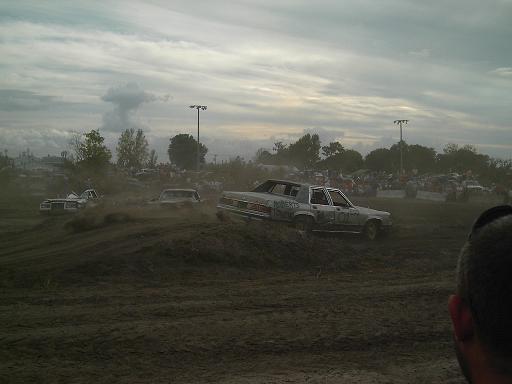 Cars in a demolition derby, one with "WILD THING" on its side