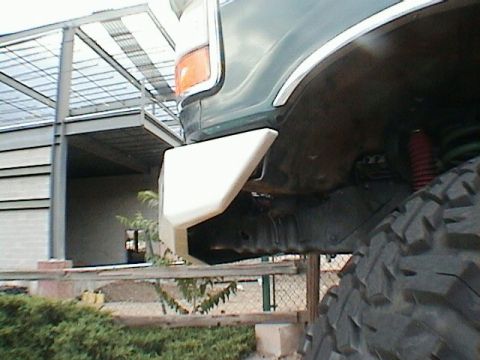 1993 Ford Bronco - A custom bumper is installed on the front of an off-road vehicle, with a large tire visible.