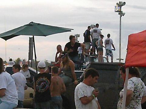 1986 Ford Bronco - A group of people are gathered around vehicles at an outdoor event.