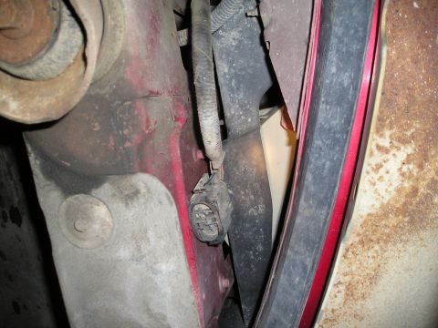 1997 Ford F-250 - Detail of a vehicle's electrical connector and wiring, showing some rust on surrounding metal.