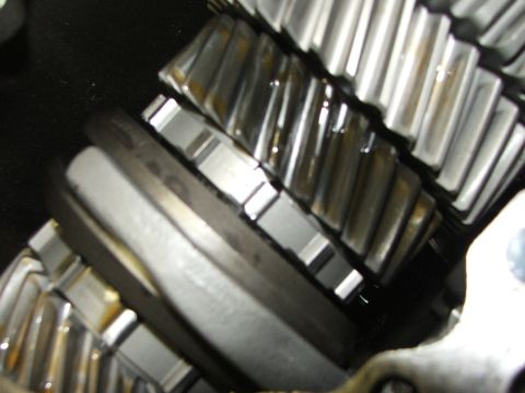 1965 Ford Mustang - Close-up view of meshing metal gears, likely from a transmission or differential, coated in oil.