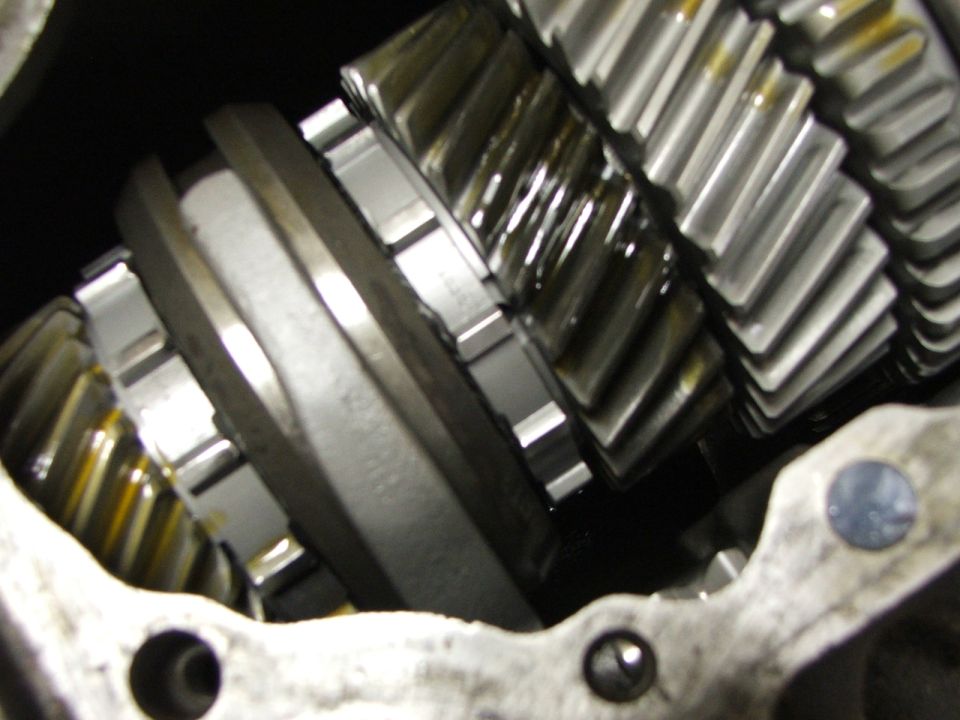 Close-up of transmission gears with oil