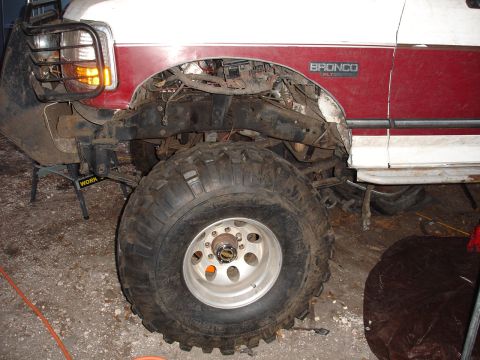 1989 Ford Bronco - Front end of a 1989 Ford Bronco with fender removed for repairs or modifications.