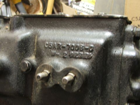 1965 Ford Mustang - Close-up of a black metal engine part showing casting numbers C5AR-7006-D and 1422.