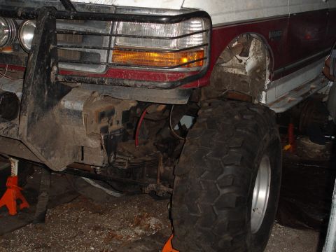 1989 Ford Bronco - Front view of a 1989 Ford Bronco with a large off-road tire and custom bumper.