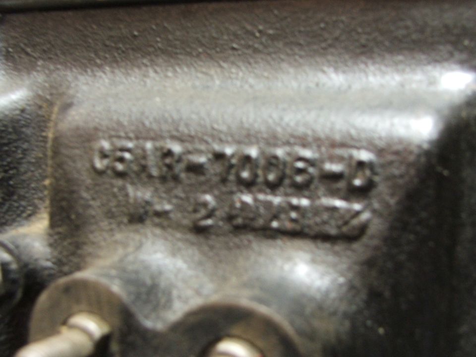 Close-up of a metal part with casting numbers C5RR-7006-D and 14-2 0782