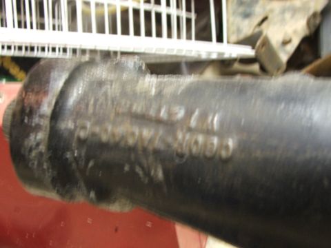 1965 Ford Mustang - A close-up shows stamped casting numbers on a dark metal automotive part.