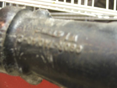 1965 Ford Mustang - Close-up of a part with embossed text, likely from a vehicle.