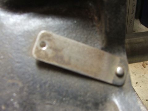 1965 Ford Mustang - Metal identification plate attached to a component, likely from a vehicle's engine bay.