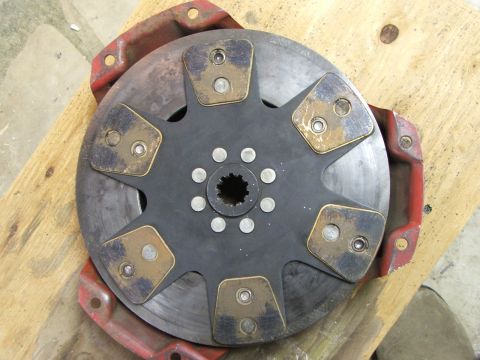 1965 Ford Mustang - A clutch disc, likely for a manual transmission, is shown with its characteristic splined hub and friction material pads.