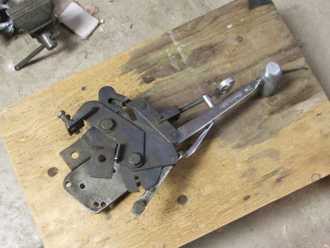 1965 Ford Mustang - Mechanical linkage part with clamp and hammer head on a wooden board.