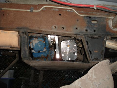 1989 Ford Bronco - Close-up view of the undercarriage, revealing drivetrain parts and a branded metal plate.