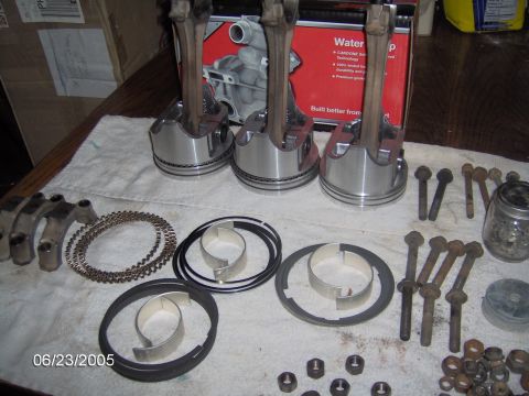 1978 Ford Bronco - Engine pistons, connecting rods, and related parts are laid out on a cloth for assembly.