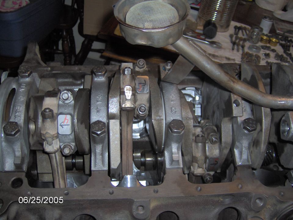 Engine block with crankshaft and connecting rods, oil pickup tube visible