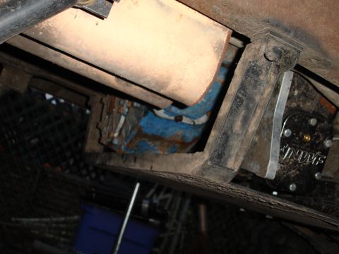 1989 Ford Bronco - Underside view of vehicle with exhaust and blue component, plus a labeled metal part.