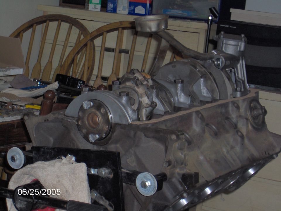 Engine block with crankshaft and connecting rods, on a stand. Date stamp 06/25/2005