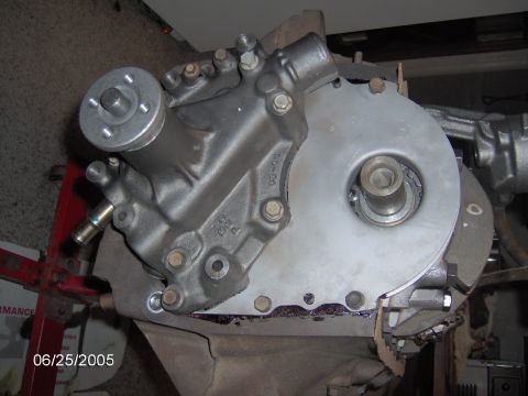 1978 Ford Bronco - Close-up view of an engine's water pump and timing cover, likely during a rebuild or repair process.