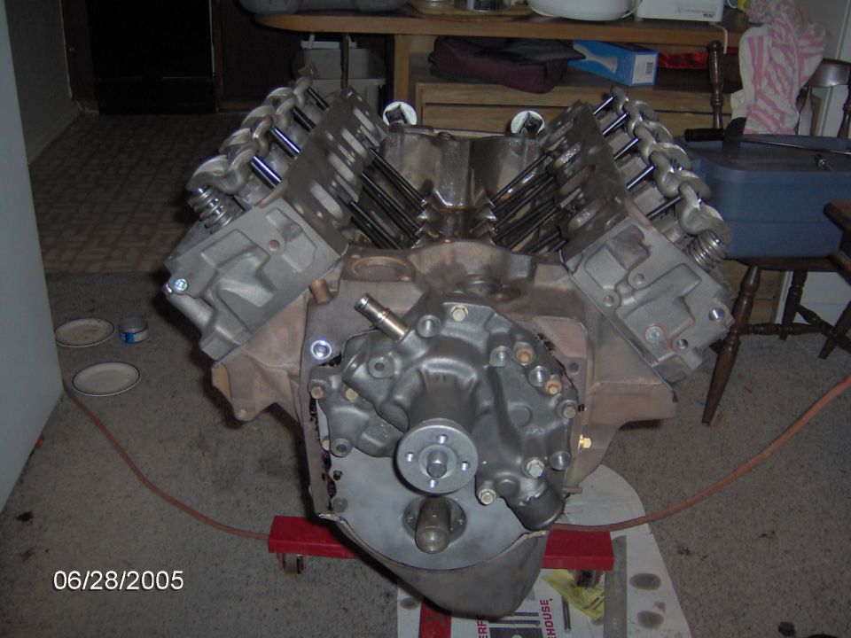 V8 engine on a red stand, showing the intake manifold and valve covers