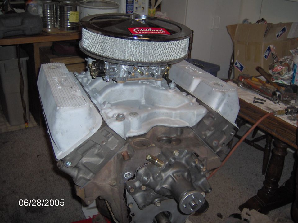 Engine block with silver valve covers and chrome air cleaner. Date stamp reads 06/28/2005