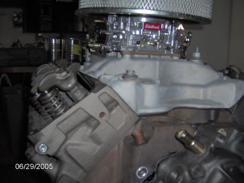 1978 Ford Bronco - Close-up view of an engine's intake manifold, carburetor, and air filter assembly.