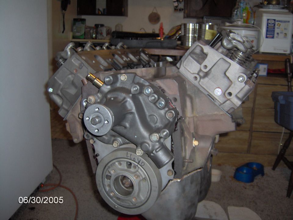 Engine block with water pump and crankshaft pulley. Text "LLOYD" visible on pulley