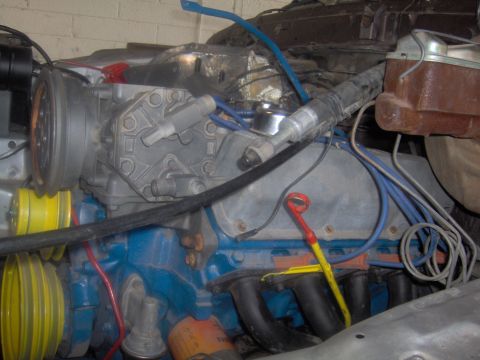 1978 Ford Bronco - Close-up view of an engine bay, focusing on the air conditioning compressor and other engine components.