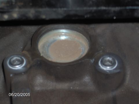 1978 Ford Bronco - Engine component detail with visible bolts and a plug.
