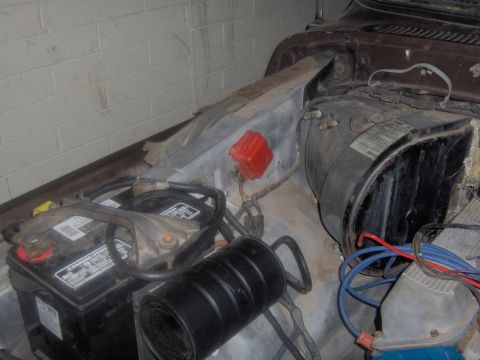 1978 Ford Bronco - Close-up view of the engine bay, showing the battery and various engine parts.