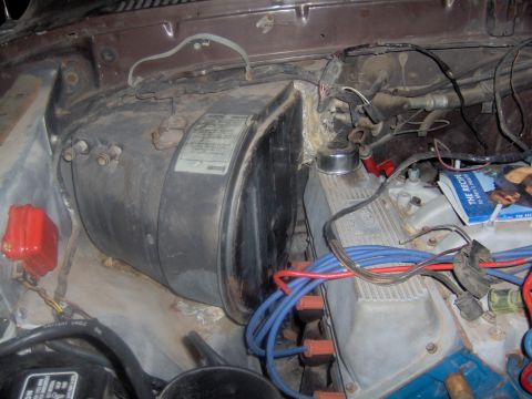 1978 Ford Bronco - The engine bay contains a large black heater core housing and various engine components, with visible spark plug wires.