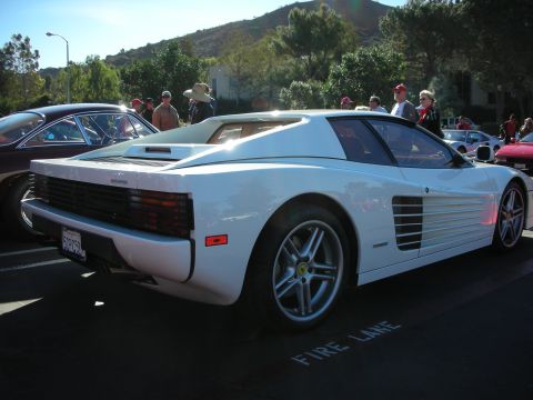 1992 Ford Crown Victoria - White Ferrari Testarossa parked next to another car, with people in the background.