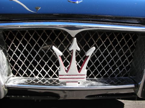 1992 Ford Crown Victoria - The iconic Maserati trident emblem is centered on the vehicle's front grille.