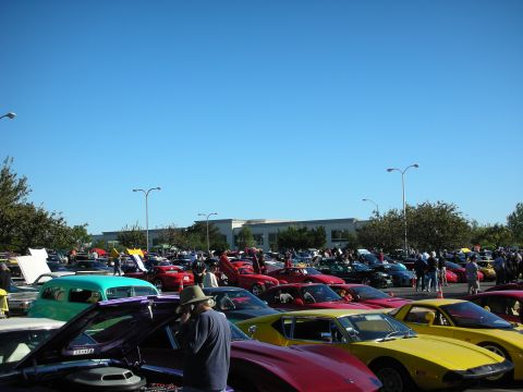 1992 Ford Crown Victoria - A wide shot captures a car show event with numerous vehicles on display under a bright, clear blue sky.
