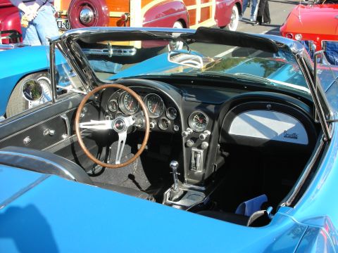 1992 Ford Crown Victoria - The interior of a blue convertible shows a wood-rimmed steering wheel and the 'Corvette' script on the passenger side dash. Other vintage c…