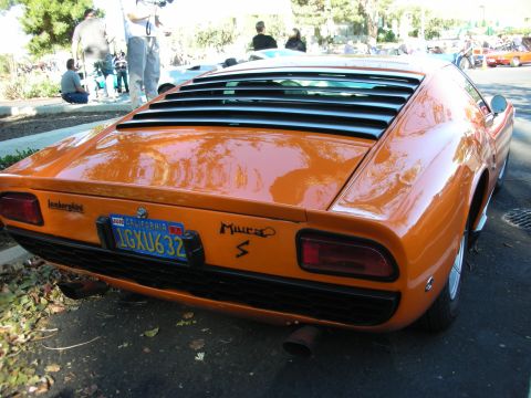 1992 Ford Crown Victoria - Rear view of an orange Lamborghini Miura S with louvers on the rear window.