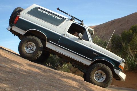 1993 Ford Bronco - This 1993 Ford Bronco navigates a steep, rocky trail with its two-tone paint scheme and off-road tires.