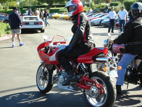 1992 Ford Crown Victoria - Motorcycle gathering with several vehicles and people in attendance.